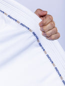 A hand holds the collar of the SEKAI 3.0 BJJ Gi White Navy, featuring the brand name repeatedly printed in blue along the edge.